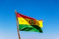 Bolivian Flag waving in the wind against blue sky background Royalty Free Stock Photo