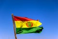 Bolivian Flag waving in the wind against blue sky background Royalty Free Stock Photo