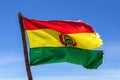 Bolivian Flag waving in the wind against blue sky background Royalty Free Stock Photo