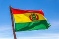 Bolivian Flag waving in the wind against blue sky background Royalty Free Stock Photo