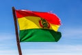 Bolivian Flag waving in the wind against blue sky background Royalty Free Stock Photo