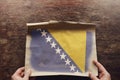 The national flag of Bosnia and Herzegovina on a torn piece of paper Royalty Free Stock Photo