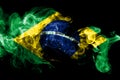 National flag of Brazil made from colored smoke isolated on black background. Abstract silky wave background.