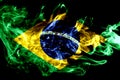 National flag of Brazil made from colored smoke isolated on black background. Abstract silky wave background.