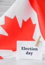 The National Flag of Canada. Canadian Flag or the Maple Leaf with paper note message text. Election day, give vote, your