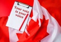 The National Flag of Canada. Canadian Flag or the Maple Leaf with paper note message text. Election day, give vote, your