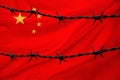 National flag of China on textured background, rows of barbed wire, concept of war, revolution, armed uprising in country,