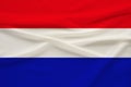 National flag of the country Holland on gentle silk with wind folds, travel concept, immigration, politics, copy space, close-up