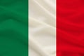 The national flag of the country of Italy on gentle silk with wind folds, travel concept, immigration, politics, copy space, close Royalty Free Stock Photo