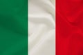 The national flag of the country of Italy on gentle silk with wind folds, travel concept, immigration, politics, copy space, close Royalty Free Stock Photo