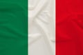 The national flag of the country of Italy on gentle silk with wind folds, travel concept, immigration, politics, copy space, close Royalty Free Stock Photo