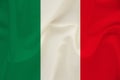The national flag of the country of Italy on gentle silk with wind folds, travel concept, immigration, politics, copy space, close Royalty Free Stock Photo