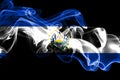 National flag of El Salvador made from colored smoke isolated on black background. Abstract silky wave background