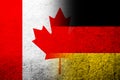 The national flag of Germany with National flag of Canada Maple Leaf. Grunge background Royalty Free Stock Photo