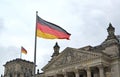 National flag of Germany flutters against the background of the Reichstag building. Berlin, Germany Royalty Free Stock Photo