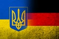 The national flag of Germany with Ukrainian national flag with Coat of arms of Ukraine tryzub. Grunge background Royalty Free Stock Photo