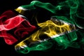 National flag of Guyana made from colored smoke isolated on black background. Abstract silky wave background. Royalty Free Stock Photo