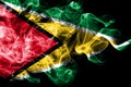 National flag of Guyana made from colored smoke isolated on black background. Abstract silky wave background Royalty Free Stock Photo