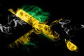 National flag of Jamaica made from colored smoke isolated on black background. Abstract silky wave background.