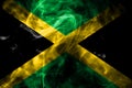 National flag of Jamaica made from colored smoke isolated on black background. Abstract silky wave background.