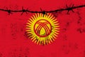 National flag of Kyrgyzstan flutters on wall with cracks, barbed wire, weapon drawing, concept of war, revolution, armed uprising