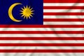 National flag of Malaysia on a silk cloth with folds from the wind, a symbol of tourism, immigration, political asylum