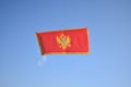 The national flag of Montenegro flying in the sky