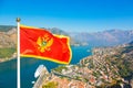 National flag of Montenegro waves in Boka Kotorska bay, Montenegro Royalty Free Stock Photo