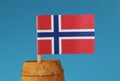 A national flag of Norway on wooden stick in wooden barrel