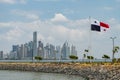 National flag of Panama with skyline of Panama City in background
