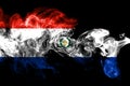 National flag of Paraguay made from colored smoke isolated on black background. Abstract silky wave background.