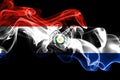 National flag of Paraguay made from colored smoke isolated on black background. Abstract silky wave background