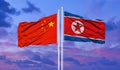 The national flag of the people`s Republic of China and the Democratic People`s Republic of Korea flutters in the wind