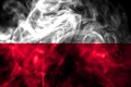 National flag of Poland made from colored smoke isolated on black background. Abstract silky wave background.