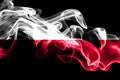 National flag of Poland made from colored smoke isolated on black background. Abstract silky wave background