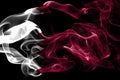 National flag of Qatar made from colored smoke isolated on black background. Abstract silky wave background. Royalty Free Stock Photo