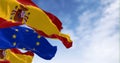 National flag of Spain waving with the European Union flag in the background on a clear day Royalty Free Stock Photo