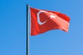 National flag of Turkey blowing in the wind against a blue sky. Symbol of Turkish people Royalty Free Stock Photo