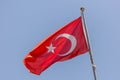 The national flag of Turkey against the blue sky. Royalty Free Stock Photo