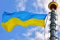 The national flag of Ukraine flutters against the blue sky Royalty Free Stock Photo