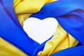 National flag of Ukraine in form of heart. Fabric curved flag in yellow-blue colour in heart-shaped on white background.