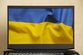 The national flag of Ukraine is yellow-blue as a background on a laptop, peace in Ukraine, no war, free country Ukraine