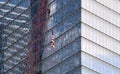 The national flag of USA, United States of America, is hanged on by a crane In front of One World Trade Center