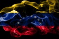 National flag of Venezuela made from colored smoke isolated on black background. Abstract silky wave background. Royalty Free Stock Photo