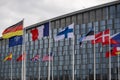 The national flags of countries member of the NATO fly outside the organisation headquarters in Brussels, Belgium on April 20 2023 Royalty Free Stock Photo