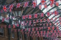 National flags hanging in row from ceiling inside Convent Garden in London
