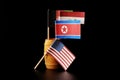A national flags of North korea, Iraq and Afghanistan in small wooden barrel Royalty Free Stock Photo