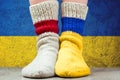 National flags of Ukraine and Belarus on a pair wool knitted socks. Symbolizing a relationship, dialog, fighting against war