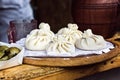 National Georgian cuisine Khinkali wooden background Cook prepares khinkali kitchen Top view raw meat dough dish uncooked Street f