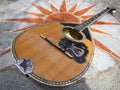 The national Greek stringed plucked musical instrument Bouzouki lies on a marble table in Greece